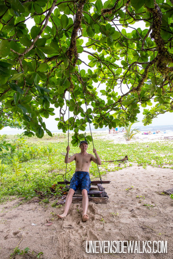 Landon riding a Tree Swing on the Beach